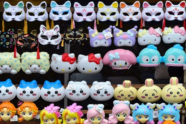 A wall of anime dolls — hello kitty and others, ad some cat masks