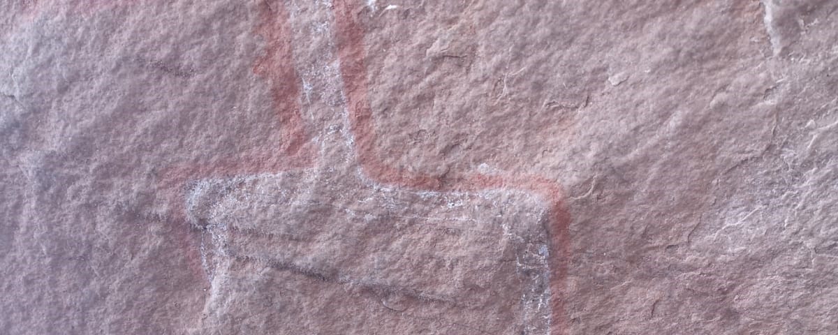 Ancient cave drawings of one large person standing with smaller versions below-Community and family symbols