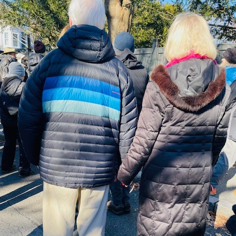 Elderly couple holding hands