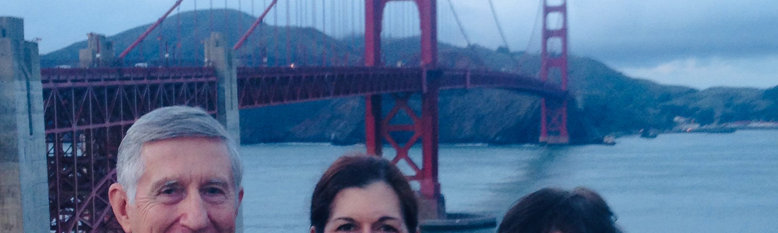 Adult with her parents in 2014 with the Golden Gate Bridge behind them