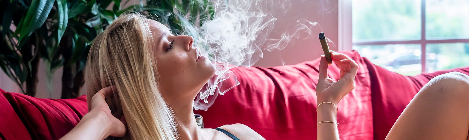 Blonde woman, blue lingerie, smoking blunt