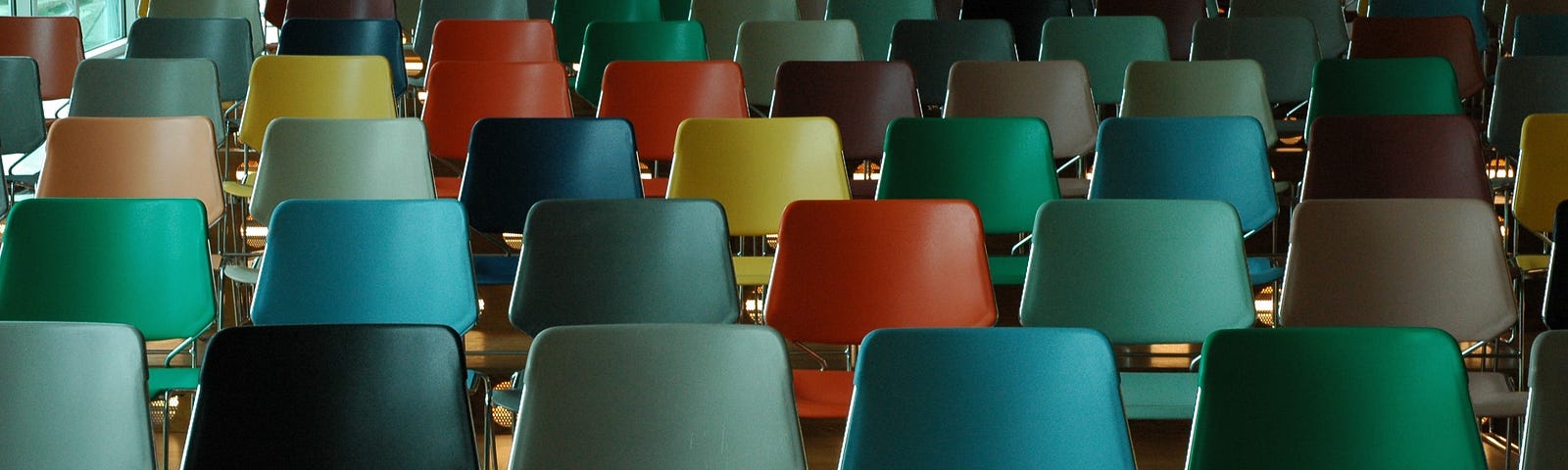 Empty lecture hall with many colorful chairs