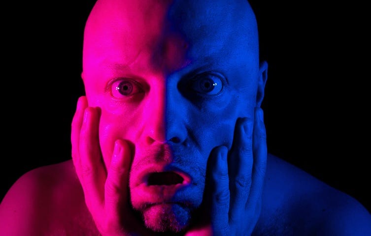 An image of the author imitating the screaming man, with blue and red studio lighting