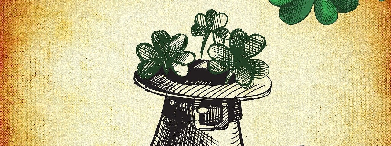 An illustration of a leprechaun hat filled with clovers against a burnt yellow background with a few clover leafs surrounding the frame.
