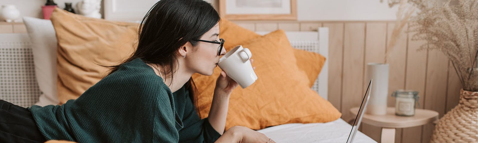 Woman sipping tea as she does a free online course to upgrade her content creation skills