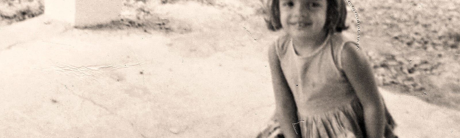 CM Torres, at four years old, wearing a dress and the strappy shoes her mother bought her to try to keep her from taking them off