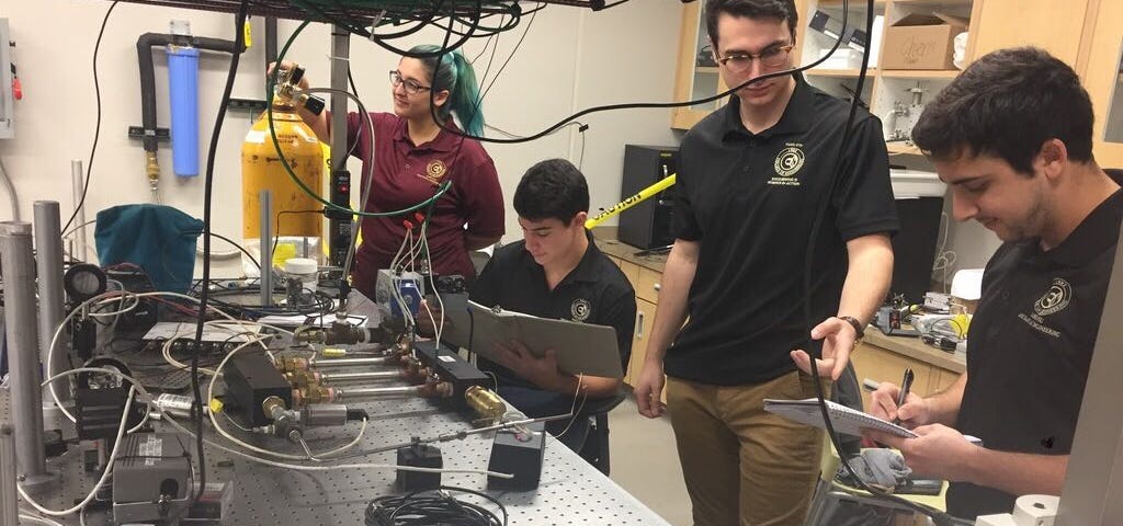 Four students working in an engineering lab at their university.