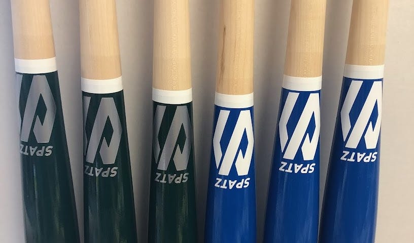 baseball bats all lined up next to each other