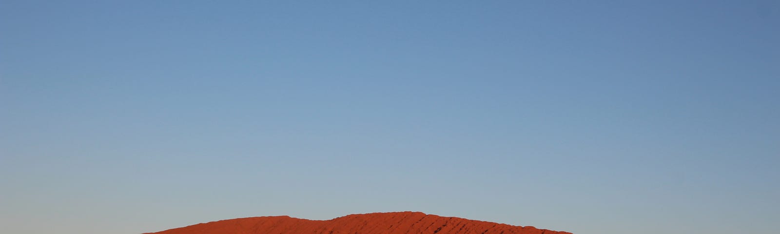 Uluru in the golden hour before sunset.