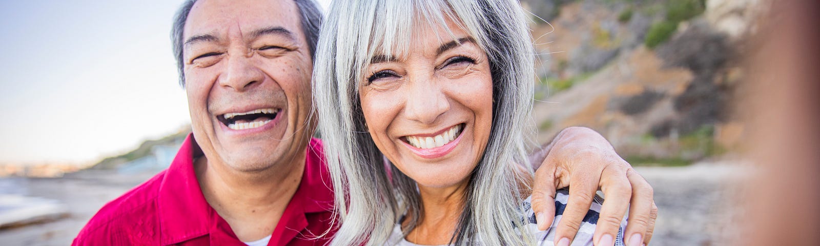 Senior Hispanic Couple Taking a Selfie at the Beach.