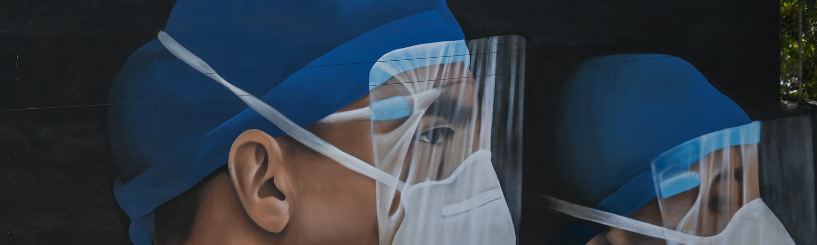 A woman wearing a face mask walks past a mural of medical workers.