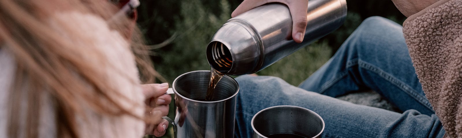 couple drinking coffee out of a thermos