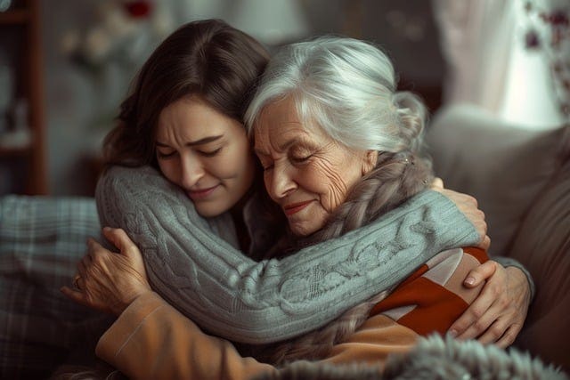 A dark-haired woman hugs a grey-haired older woman