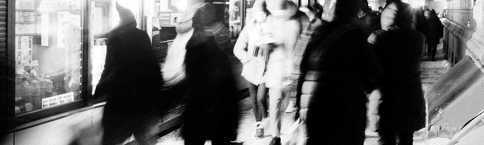 a blurred image of travelers walking down an airport corridor