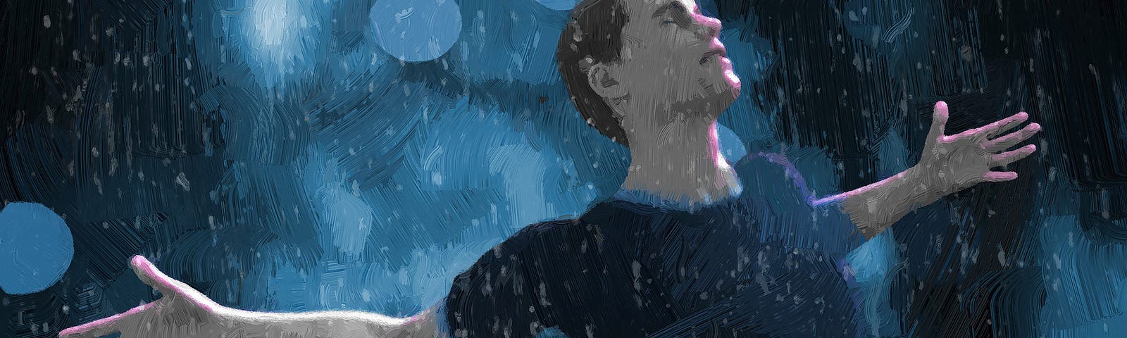 A man in a blue shirt against a blue background. His eyes are closed and his arms are open wide. It is raining on him.
