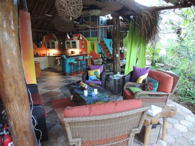 Colorful outdoor living room and a kitchen in a palapa