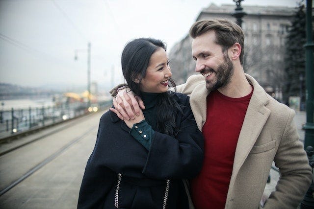 A man and woman smiling at each other.