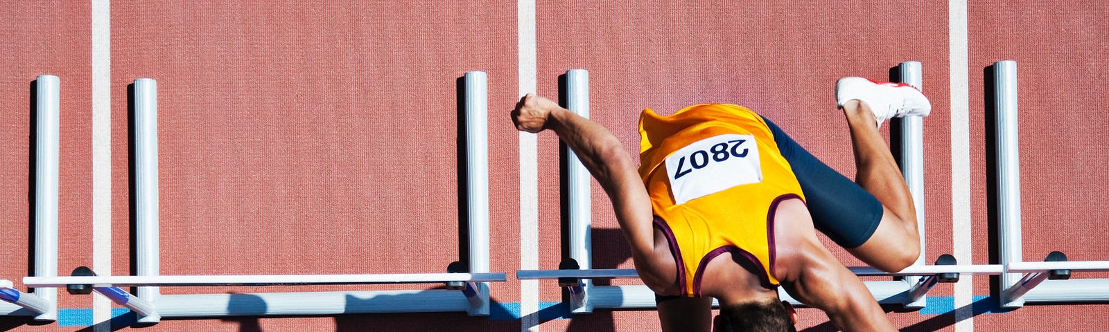 Sprinter jumping over hurdles.