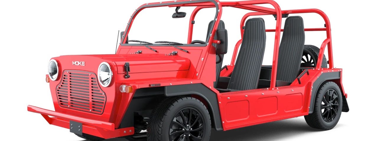 A side-profile view of a red MOKE and its Jeep-like demeanor.
