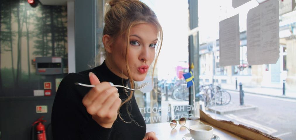 a girl eating from a plate of food