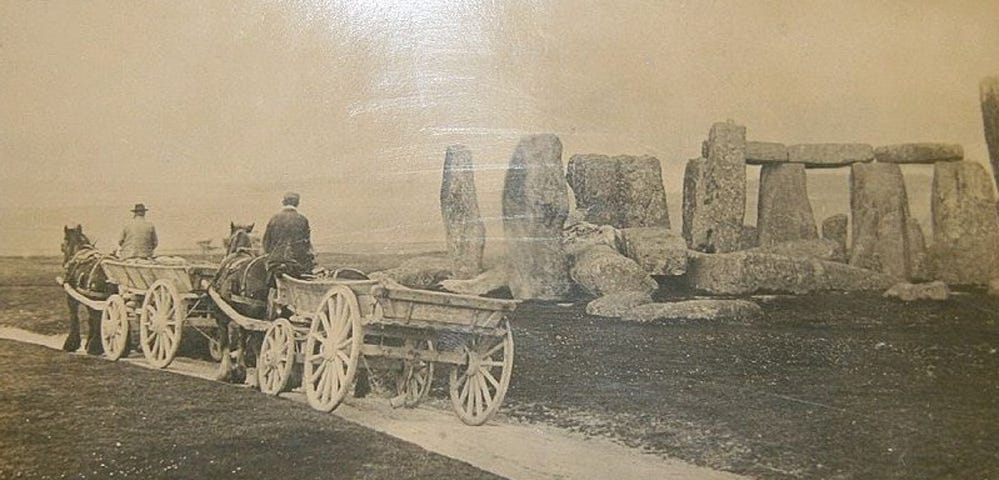 Photo of Stonehenge with horse-pulled carts crossing the henge. c.1885