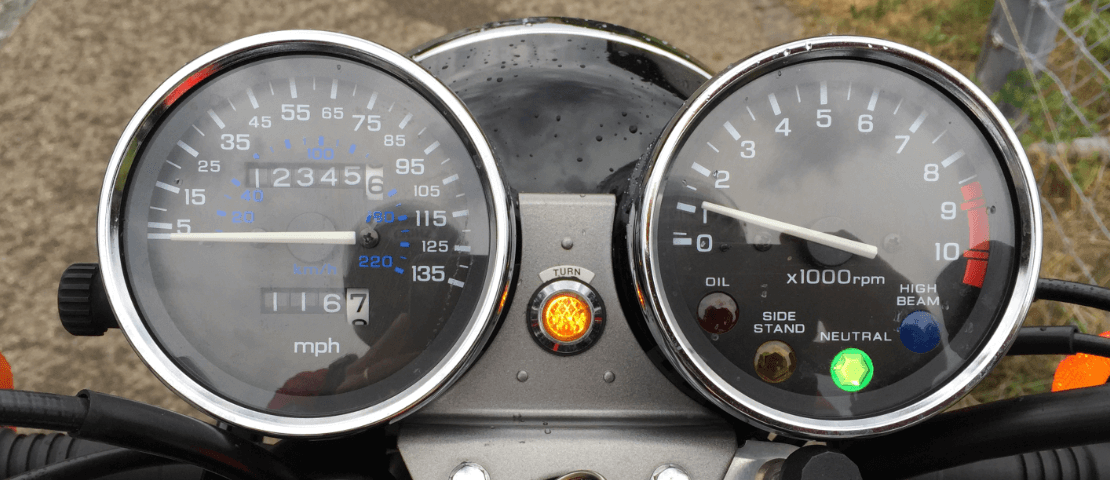 Motorcycle instrument panel with odometer showing 123456