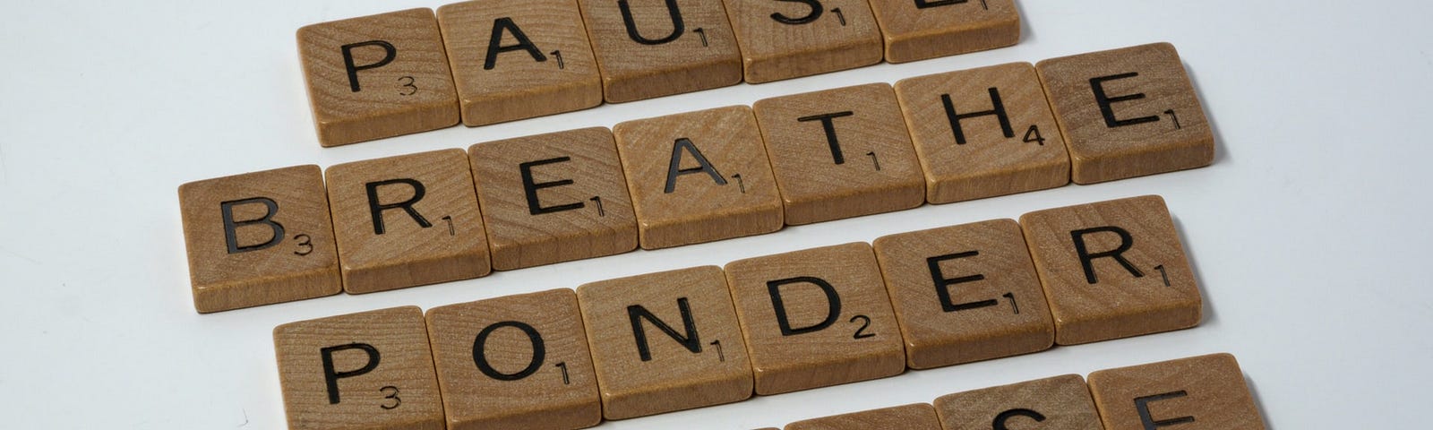 Scrabble pieces that say pause, breathe, ponder, choose, do