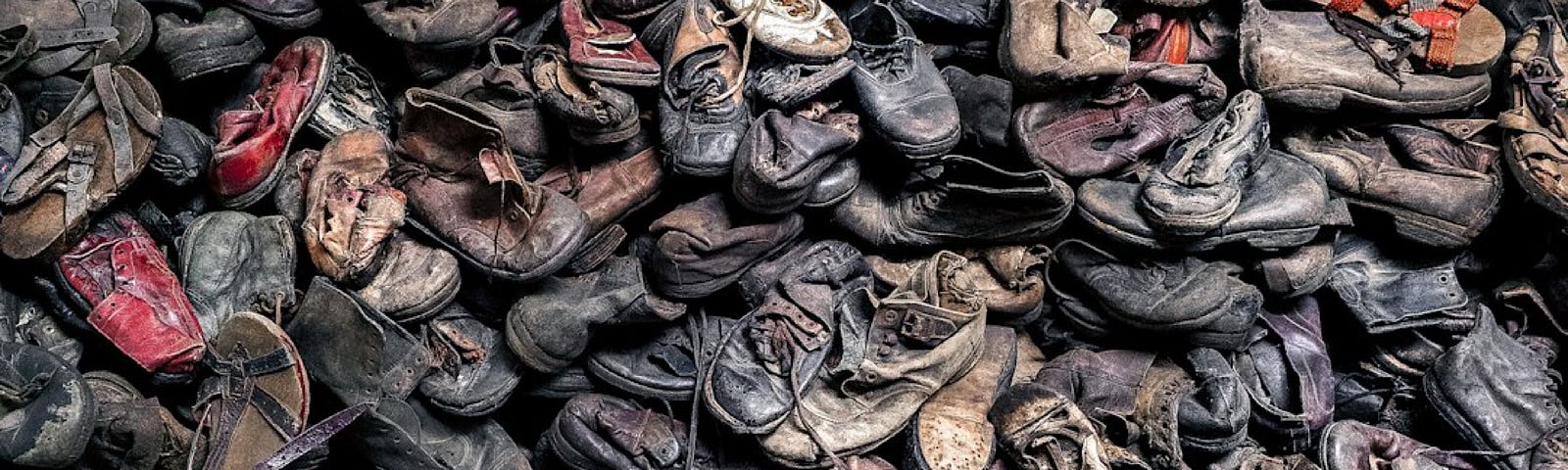 A huge pile of shoes in all colors and shapes, including children’s shoes. The photo documents restored and preserved belongings of Holocaust victims.