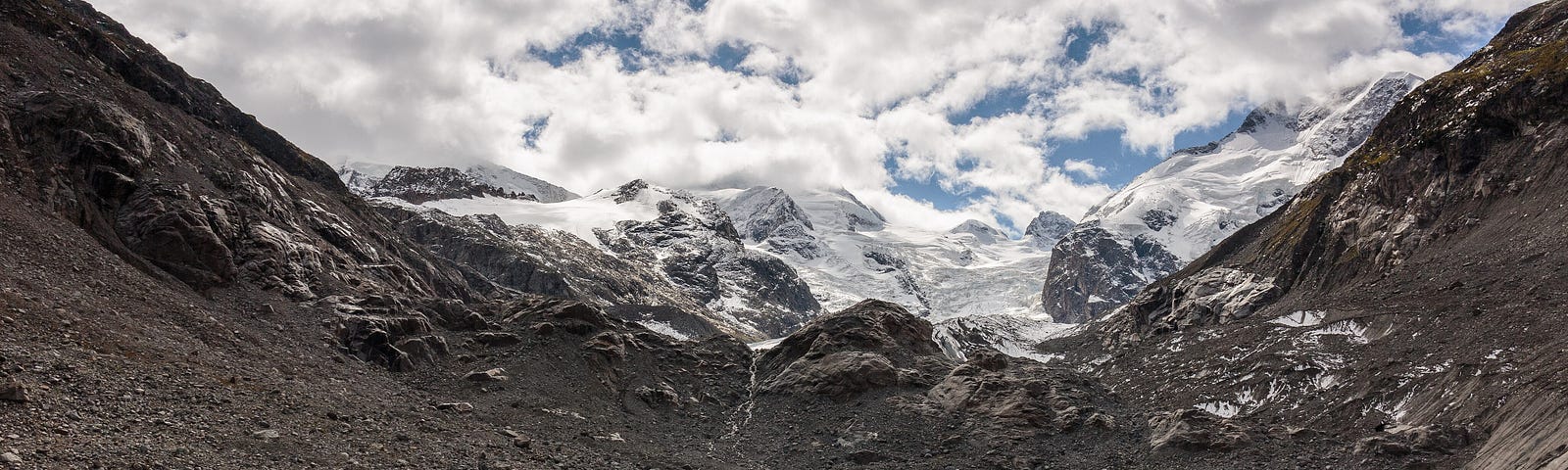 Mountain path to the tongue of the Morteratsch glacier. View of the impressive Morteratsch glacier. Walking tours from Val Sinestra (1474 meters), in Unterengadin in Graubünden, Switzerland. We have to go all the way to realized that we never left home.