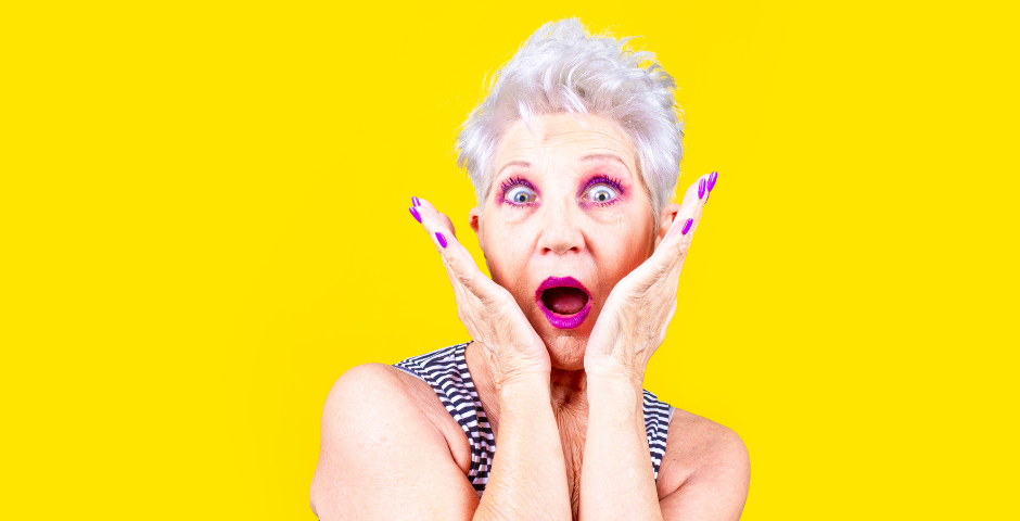 Shocked woman with yellow background