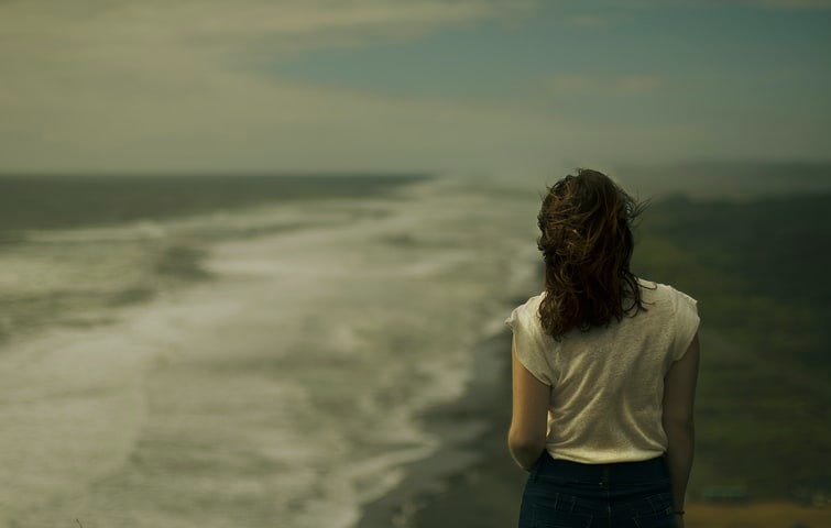 woman standing near a seashore