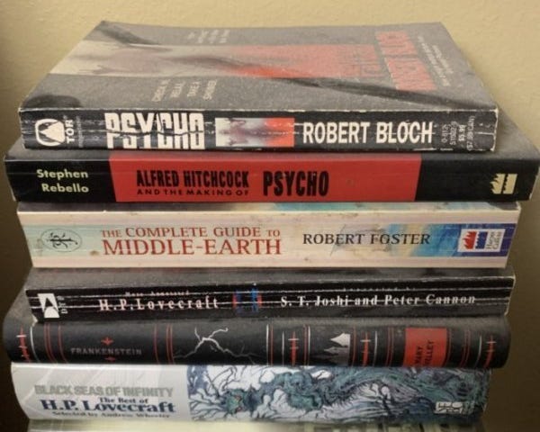 A stack of the author’s dusty books