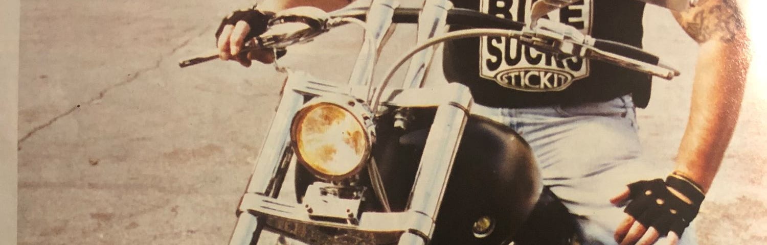 The author on a Harley Davidson motorcycle looking at the camera