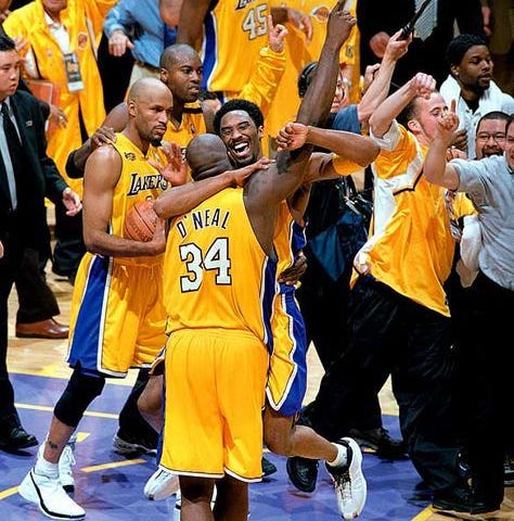 Kobe Bryant and Shaq O’Neal embrace after winning a championship.