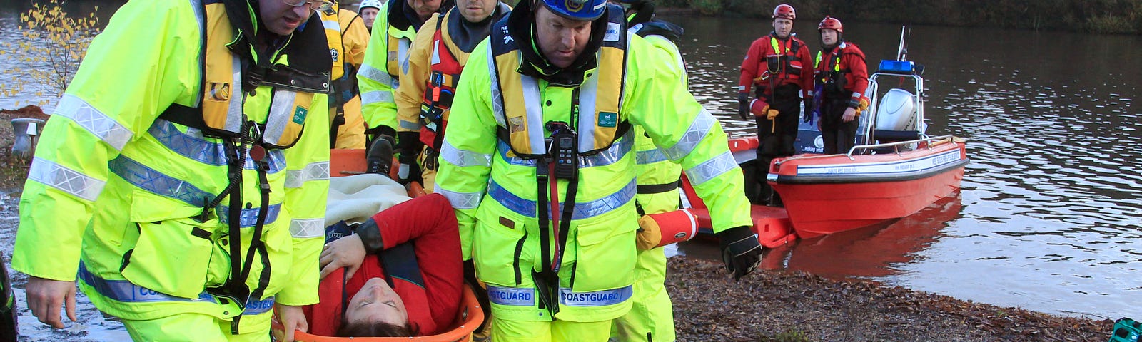 Emergency services workers rescue volunteers posing as flood victims during an exercise on flood response in Surrey, England, November 18, 2010. Photo by Luke MacGregor/Reuters