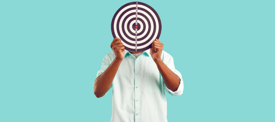 Man holding a large target in front of his face