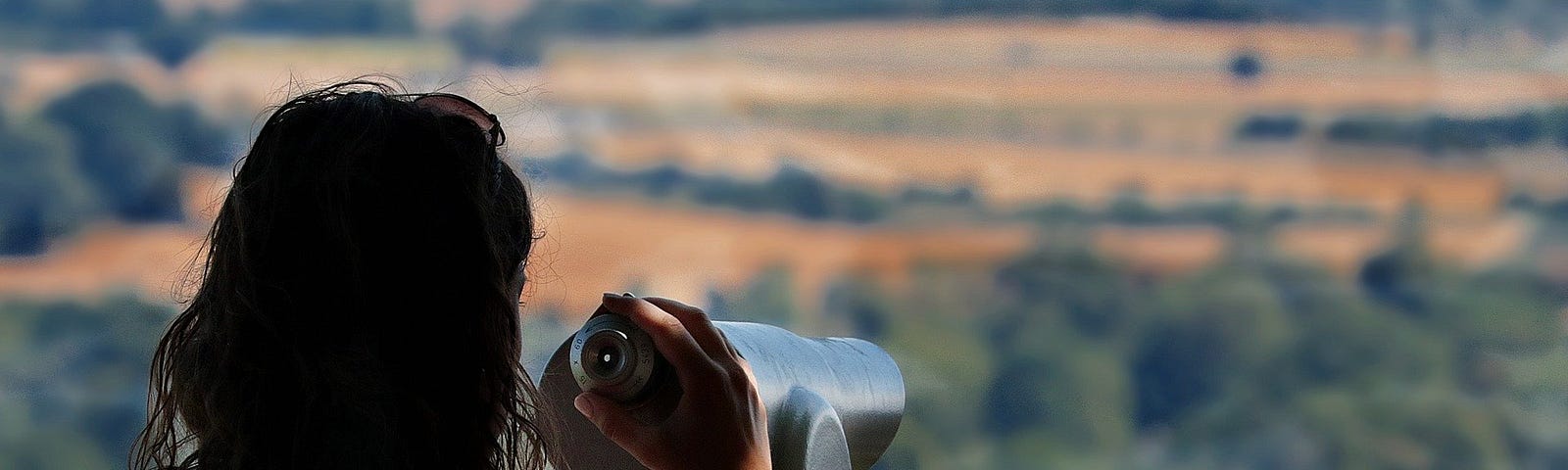 Young woman, getting ready to look at our beautiful earth through a telescope.