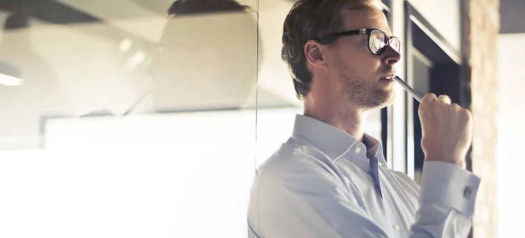 man standing in front of window