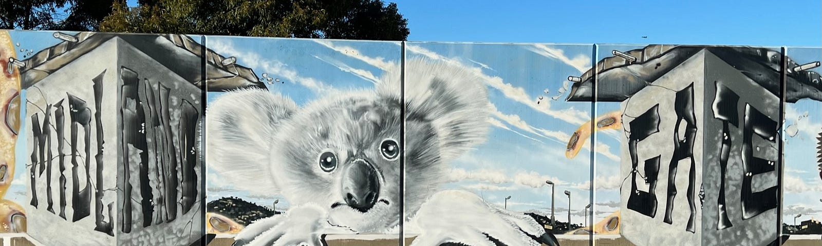 Artwork of a Koala gripping the edges of a concrete carpark