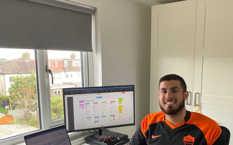 An image of the author sitting at his desk in his home office, with the course materials visible on a computer screen