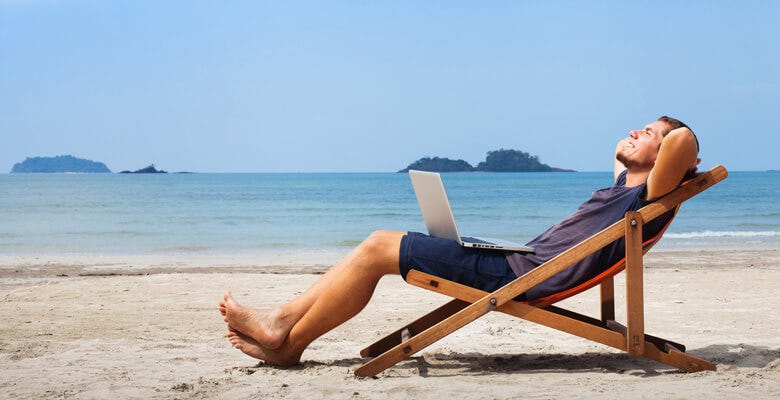 Relaxed designer working from the beach.