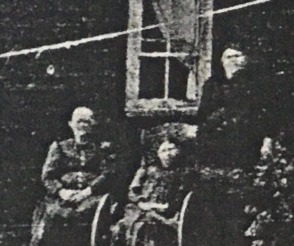 Three people in front of a window in about 1900