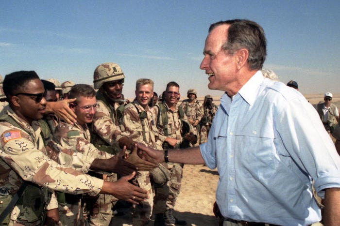 President George H.W. Bush meets with troops in Saudi Arabia on Thanksgiving during the Gulf War, November 22, 1990.