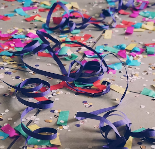 Colorful ribbon and confetti on sidewalk