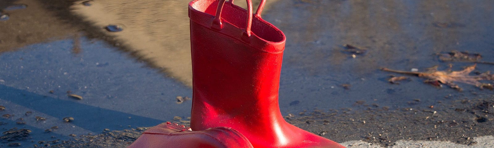 A pair of red children’s puddle splashing boots.