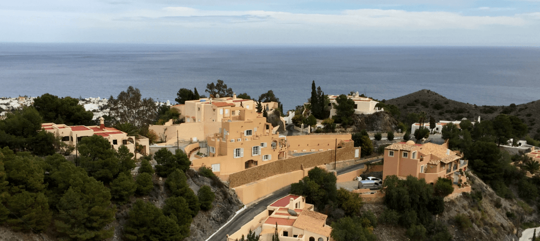 Whitewashed Mediterranean houses with sea in background