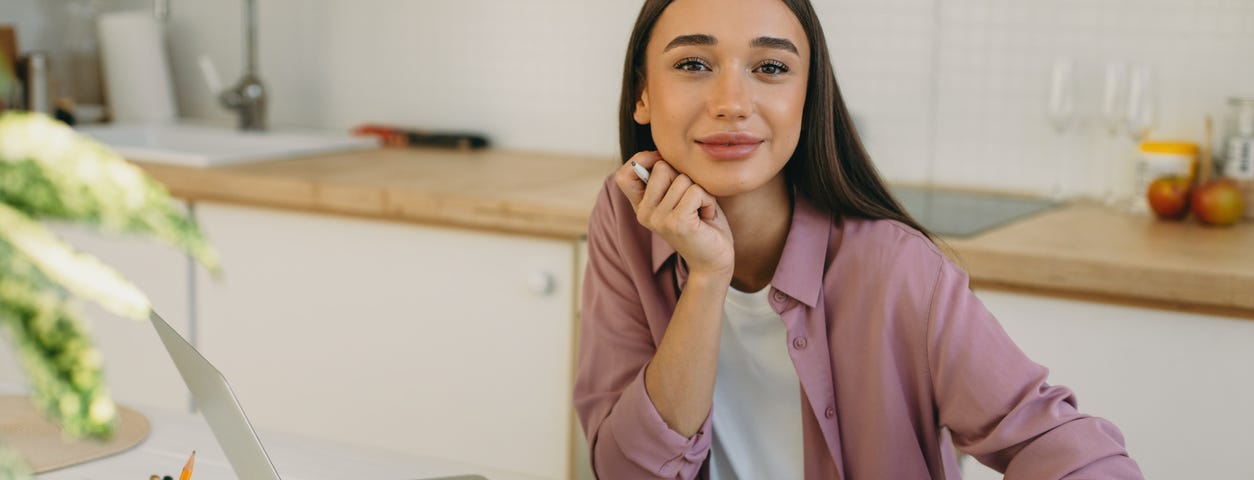 Photo of a writer, a young beautiful woman with a robotic arm by shurkin_son on iStock