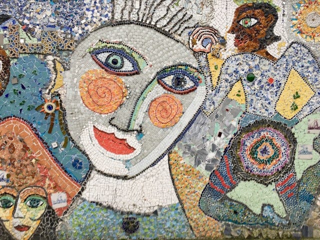 Modern mosaic portrait of a woman with other figures in the background.