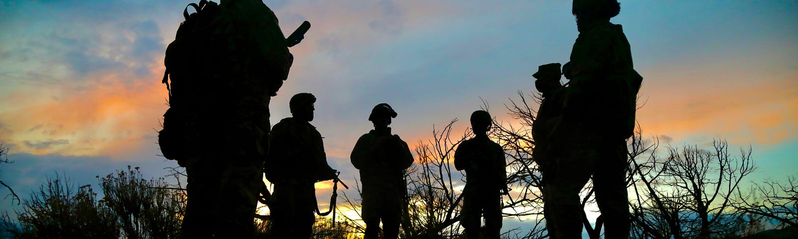 U.S. soldiers gather as the sun sets at Camp Williams, Utah, April 16, 2021. Photo by Sgt. 1st Class Brent Powell/U.S. Army