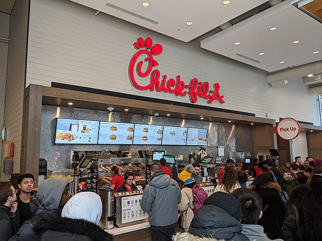 More than 50 people are waiting to eat at Chick-fil-A restaurant to eat.